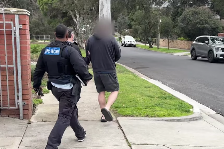 Police escorting John Setka from his Footscray home after his arrest on 14 August 2026