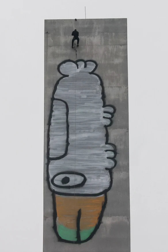 Jack Gibson-Burrell abseiling down the Bolte Bridge tower above his "Pam the Bird" graffiti tag